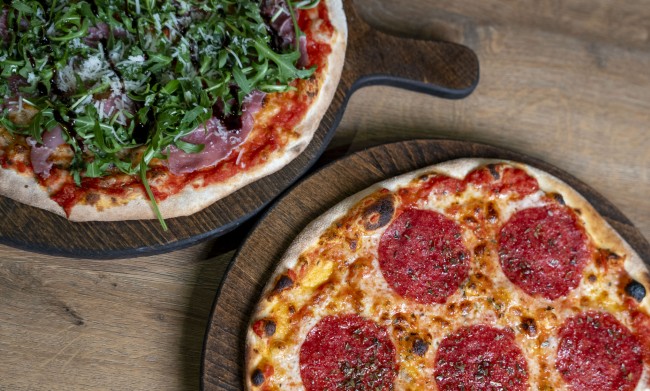 twee heerlijke pizzas één met pepperoni en één met rucola en ham