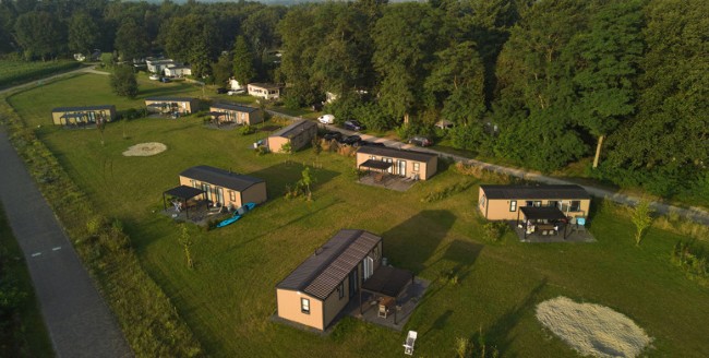 luchtfoto van moderne vakantiehuisjes midden in het groen