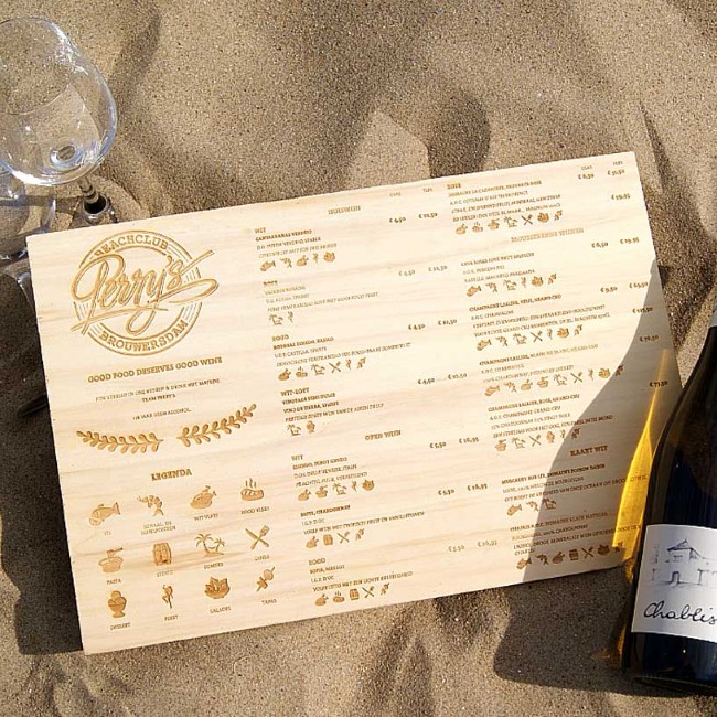 originele wijnkaart op houten plank gepresenteerd op het strand